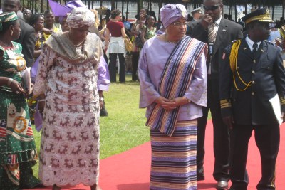 President Sirleaf waits to greet her guests arriving for an event.