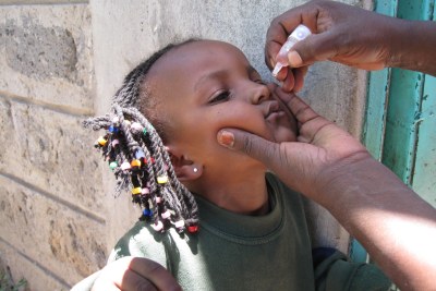 A health worker administers the polio.