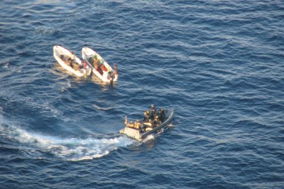 Pirate suspects, left, being seized by European naval forces off the coast of Somalia.