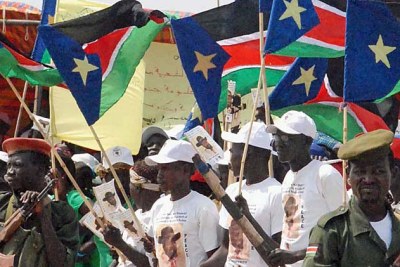 Sudanese supporters of the south's SPLM party wave the southern flag at a rally in Bentiu, state capital of Unity.