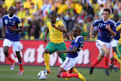 Katlego Mphela of South Africa tackled by William Gallas of France at the 2010 World Cup.