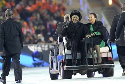 Nelson Mandela, 91, wrapped up against a cold winter night in Johannesburg, and his wife, Graca Machel greet 85,000 spectators at the World Cup final.