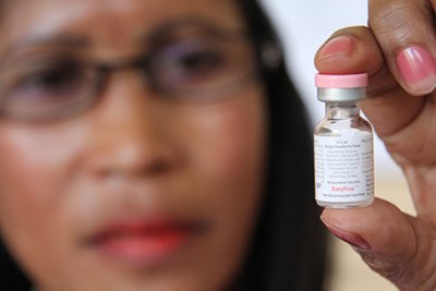 A midwife holds up a vial of a vaccine at a clinic in Madagascars capital, Antananarivo.