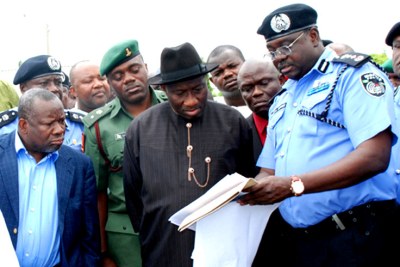 President Goodluck Jonathan and Police Inspector General Hafiz Ringim inspect the remains of car bomb in Abuja last June.
