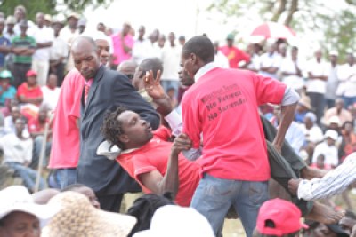 An MDC-T activist is ejected from Chibuku Stadium after skirmishes at the partys rally in Chitungwiza