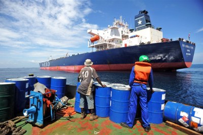 A crew member prepares to board a tanker.