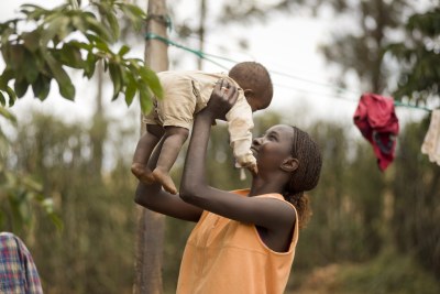 A mother plays with her young son in the Kenyan village of Mwea.