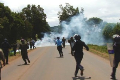 Police chasing after protesters during the general elections.