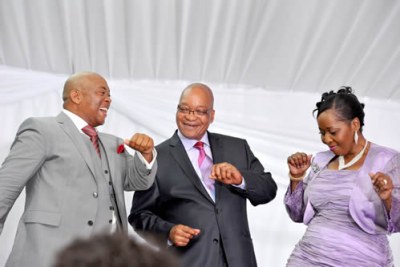 President Jacob Zuma, center, with his wife Bongi Ngema dance on their wedding day with Linda Sibiya who was host at the reception function.
