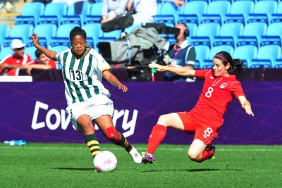 Gabisile Hlumbane of South Africa challenged by Canada's Diana Matheson during their Olympic Women's football clash on July 28.