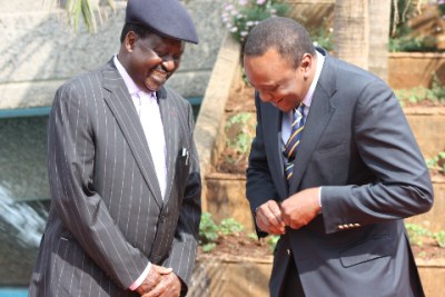 Opposition leader Raila Odinga (left) with President  Uhuru Kenyatta share a light moment (file photo).