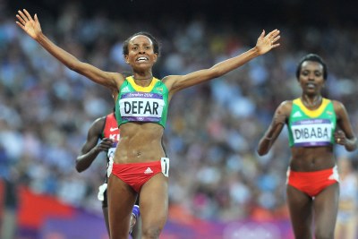 Ethiopia's Meseret Defar celebrates winning the gold medal in the women's 5000m final, beating her teammate - and 10000m gold medallist - Tirunesh Dibaba, who won bronze.