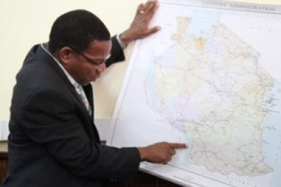 Minister for Foreign Affairs and International Cooperation, Bernard Membe points to a median line border between Tanzania and Malawi on a recent administrative map of Tanzania .