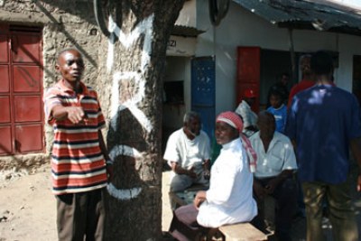 Youth stands next to wall marked MRC (Mombasa Republican Council) (file photo).