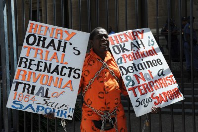 Prison rights activist Golden Miles Bhudu demonstrates outside the Johannesburg High Court, where Nigerian Henry Okah, found guilty of masterminding two car bomb blasts in Abuja, appeared for pre-sentencing proceedings.