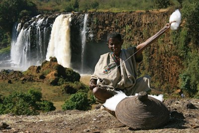 A man weaving cotton by hand near the Blue Nile in Ethiopia.