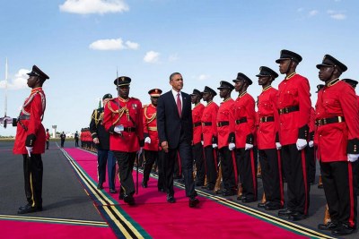 President Obama reviews Tanzanian troops at an airport arrival ceremony in Dar es Salaam.