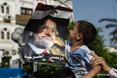 A child looks at a poster of ousted Egyptian president Mohamed Morsi (file photo).