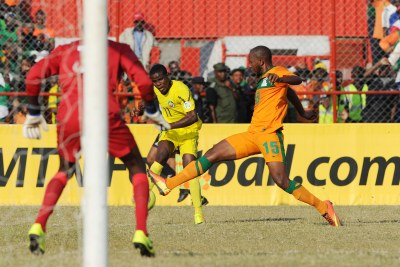 Mario Sinamunda of Mozambique challenged by  Munthali Christopher of Zambia during the Cosafa Cup Quarter Finals match between Zambia and Mozambique on the 14 July 2013 at Nkana Stadium, Zambia