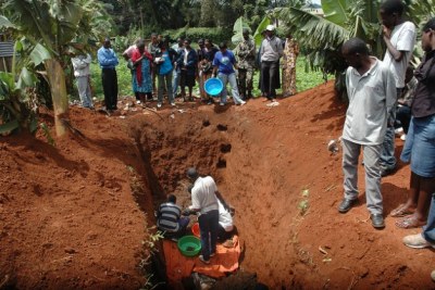 Rwandan genocide survivors exhuming the bodies of their relatives killed and buried in a mass grave during the 1994 100-day massacre.