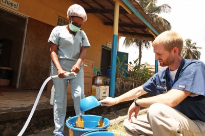 Dr. Brantly makes chlorine solution for disinfection at the case management center at ELWA Hospital in Monrovia before he was infected with the virus.