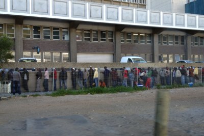 People wait outside the Department of Home Affairs Office in Cape Town (file photo).
