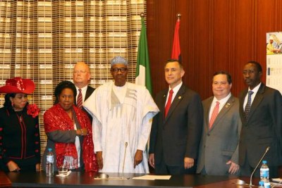 President Buhari (center) flanked (l-r) by U.S. Reps. Frederica Wilson and Sheila Jackson Lee, along with Darrell Issa and Blake Farenthol, plus U.S. Ambassador James Entwistle (rear) and National Security Adviser Babagana Monguno (right).