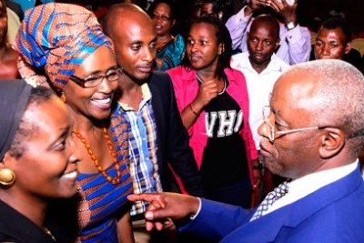 Presidential candidate Amama Mbabazi, right, chats with Oxfam Executive Director Winnie Byanyima, second from left, after the second round of the debate between the eight presidential candidates.