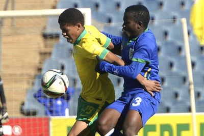 South Africa's U-17 player fights for a ball during a match against Tanzania.