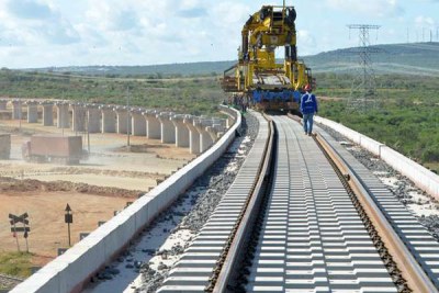 China Road and Bridge Corporation workers proceed with the construction of an overpass for the standard gauge railway, on May 25, 2016, in Taru (file photo).