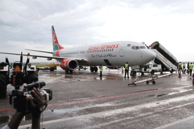 Passengers alight from a Kenya Airways aircraft at Entebbe International Airport (file photo).