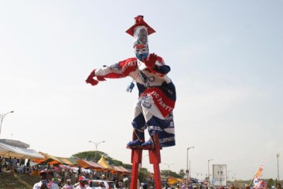 Stilt walker dressed in NPP colours wanders around Trade Fair Park.