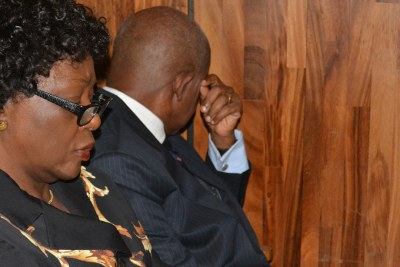 Justice Adeniyi Ademola (right) looks away from the camera while appearing before an Abuja High Court. He and his wife, Omobolanle (left) were granted bail. (file photo).