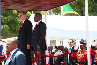 John Magufuli and his Turkish counterpart Recep Tayyip Erdogan observe the national anthems of their countries at the State House grounds in Dar es Salaam.
