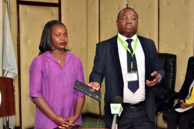 IEBC ICT Director Chris Musando (right) with a Safram Morpho official at a past event at the commission's offices in Nairobi.