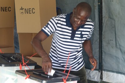 A voter casts his ballot in the first round.