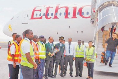 Kilimanjaro International Airport officials pose for a photo with Ethiopian airline staff after the aircraft landed at KIA.