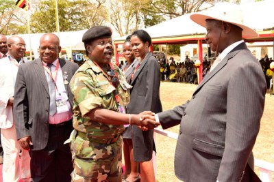 Steven Sempagala, aka Sgt Kifulugunyu, greets President Yoweri Museveni after he was awarded the Luweero Triangle medal.