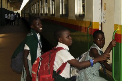 Children board a train in Kampala recently.
