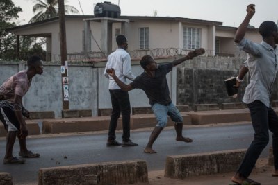 Supporters of the opposition Sierra Leone People's Party throw rocks at police following an alleged incident at party headquarters in Freetown's Goderich neighborhood (file photo).