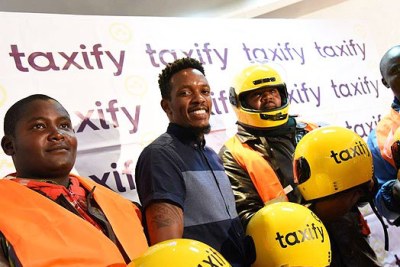 Taxify city manager Alex Mwaura (centre) with boda boda riders during the launch of boda boda hailing service on March 15, 2018.