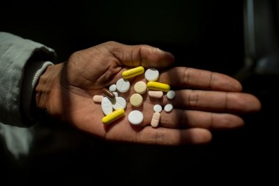 Simphiwe holds his medication, he takes up to 26 pills a day to treat XDR-TB.