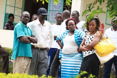 Sharon Otieno's parents Douglas Otieno (in black cap) and Melida Auma (second right) with their relatives at Homa Bay where Migori Governor Okoth Obado's personal assistant Michael Oyamo was to be arraigned over the abduction and murder of their daughter in the picture taken on Tuesday September 11, 2018.