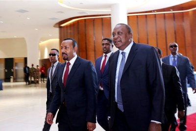 Ethiopian PM Abiy Ahmed, left, and Kenya's President Uhuru Kenyatta attend the Kenya-Ethiopia Trade and Investment Forum in Addis Ababa on March 1, 2019.