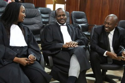 Richard Mugisha (right) consults with his lawyers Moise Nkundabarashi and Florida Kabasinga (left) at the Supreme Court where the landmark ruling in the case filed by Mugisha, challenging some of the provisions in the law that went into force in August, 2018.