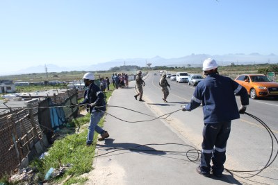 Eskom employees removing illegal connections (file photo).