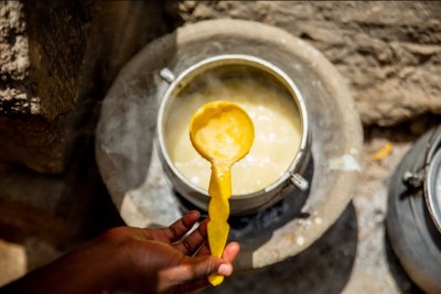Amina prepares a meal for her son. For the last three years, WFP has supported her with monthly food rations and nutrition supplements for her youngest child, Muhammed.