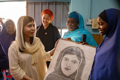 Malala Yousafzai is presented with a portrait by students of the Lafiya Sariri Learning Centre students in Borno state, North-eastern Nigeria. Deputy Secretary-General Amina J. Mohammed looks on.