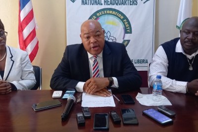 Allen Brown (center), Presidential candidate from the Liberia Restoration Party, addressing the media in Monrovia and introucing his running mater, Vice Presidential candidate, Noosevett Janice Weah (left).