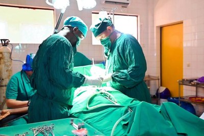 In the operating theatre of the Regional Hospital Labé, Dr. Kindi Diallo and his team  perform surgery on a woman living with obstetric fistula.